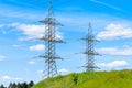 High-voltage power pylons in the field Royalty Free Stock Photo