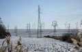 High voltage power towers in winter. Electricity pylons, transmission towers. Blue sky in the background Royalty Free Stock Photo