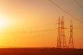 High-voltage power transmission line. Energy pillars. At sunset, dawn. high-tension Royalty Free Stock Photo