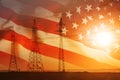 High-voltage power transmission line. Energy pillars. At sunset, Flag of United States of America Royalty Free Stock Photo