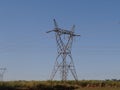 high voltage power transmission tower in countryside blue sky green area Royalty Free Stock Photo