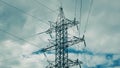 High Voltage Power Transmission Tower Standing Majestically Against a Dramatic Sky Royalty Free Stock Photo