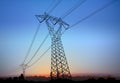 High Voltage Pylon with Electric Wires with Landscape Silhouette and Sunrise Royalty Free Stock Photo