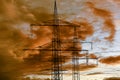 High voltage pylons for electricity and power against sky with dramatic clouds Royalty Free Stock Photo