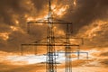 high voltage pylons for electricity and power against sky with dramatic clouds Royalty Free Stock Photo