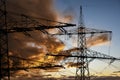 high voltage pylons for electricity and power against sky with dramatic clouds Royalty Free Stock Photo