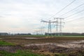 High-voltage pylons and high-voltage lines for transporting electricity from the power plant in the background Royalty Free Stock Photo