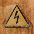 High voltage sign on a rusty steel surface.