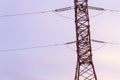 High-voltage steel tower with wires transmission of electric current against the sky