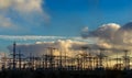High voltage switchgear equipment small clouds at sunset. Royalty Free Stock Photo