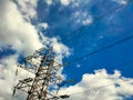 High-voltage tower against a blue sky with clouds Royalty Free Stock Photo