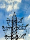 High-voltage tower against a blue sky with clouds Royalty Free Stock Photo