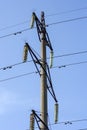 High voltage tower against the blue sky. Power lines are one of the components of the electrical network