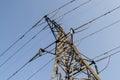 High-voltage metal tower against the sky