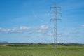 High voltage tower and cable line in the countryside under a blue sky Royalty Free Stock Photo