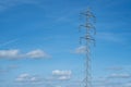 High voltage tower and cable line in the countryside under a blue sky Royalty Free Stock Photo