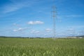 High voltage tower and cable line in the countryside under a blue sky Royalty Free Stock Photo