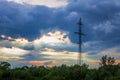 High-voltage tower dark dramatic clouds sun`s rays Royalty Free Stock Photo