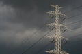 High voltage tower with electric cable and dark sky Royalty Free Stock Photo