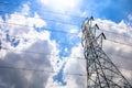 High voltage tower electric pole and wire with blue sky clouds and sun light. Royalty Free Stock Photo