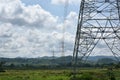 High voltage tower, Electric post and electric cable on the field in the countryside with white cloudy and blue sky background. Royalty Free Stock Photo