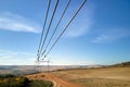 High voltage tower with electric power lines transfening electrical energy through cable wires Royalty Free Stock Photo