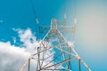 High voltage tower with electricity transmission power lines against blue sky Royalty Free Stock Photo