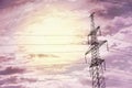 High voltage tower with electricity transmission power lines at sunset, low angle view Royalty Free Stock Photo