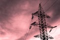 High-voltage tower metal in the dawn rays pink lilac clouds copy space