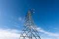 High voltage tower - Power Line against a Blue Sky with Clouds Royalty Free Stock Photo