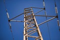 High voltage tower seen from below with a deep blue sky in the background. Concept electricity, energy, voltage, metal Royalty Free Stock Photo