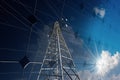 High Voltage Tower on a Solar Panel with Reflections - Renewable Energy Concept Royalty Free Stock Photo