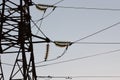 High-voltage towers against the blue sky. High-voltage electrical insulator. Electric hub on pole. Wires of high voltage in sky. Royalty Free Stock Photo