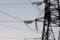 High-voltage towers against the blue sky. High-voltage electrical insulator. Electric hub on pole. Wires of high voltage in sky. Royalty Free Stock Photo