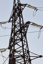 High-voltage towers against the blue sky. High-voltage electrical insulator. Electric hub on pole. Wires of high voltage in sky. Royalty Free Stock Photo