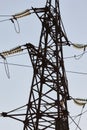 High-voltage towers against the blue sky. High-voltage electrical insulator. Electric hub on pole. Wires of high voltage in sky. Royalty Free Stock Photo