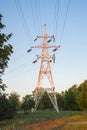 High voltage towers with electrical wires on dark cloudy sky background. Electricity transmission lines, electric power station Royalty Free Stock Photo