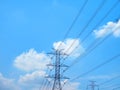 High Voltage Towers and Power Lines Against Blue Cloudy Sky Royalty Free Stock Photo