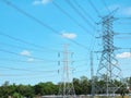 High Voltage Towers and Power Lines Against Vibrant Blue Cloudy Sky Royalty Free Stock Photo