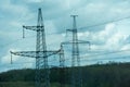 High voltage towers with sky background. Power line support with wires for electricity transmission. High voltage grid Royalty Free Stock Photo