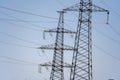 High voltage towers with sky background. Power line support with wires for electricity transmission. High voltage grid Royalty Free Stock Photo