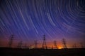 High-voltage towers and stellar trajectories Royalty Free Stock Photo