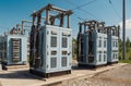 High voltage transformers at electric station on a sunny summer day Royalty Free Stock Photo