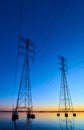 High voltage transmission lines crossing Wheeler Lake at dusk near Athens AL. Electricity pylons at sunset. Power and energy Royalty Free Stock Photo