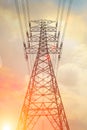 High voltage transmission tower with golden sky background at twiligh time