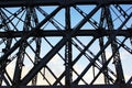 High voltage transmission tower line against blue sky, bottom view. iron construction. Royalty Free Stock Photo