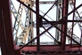 High voltage transmission tower line against blue sky, bottom view. iron construction. Royalty Free Stock Photo