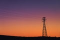 High voltage transmission tower silhouette at beautiful sunset Royalty Free Stock Photo