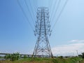 High voltage transmission towers with power line over blue sky background Royalty Free Stock Photo