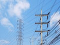 High voltage transmission towers with power line over blue sky and white cloud Royalty Free Stock Photo